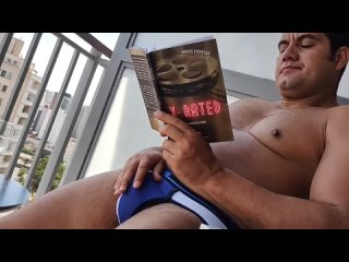 yuri gaucho jerks off on the balcony while reading a book